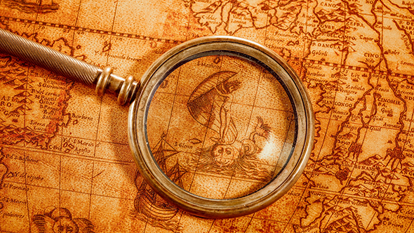 Vintage Magnifying Glass Lies On Ancient World Map