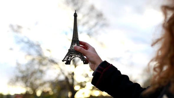Girl Holds in Hand the Eiffel Tower