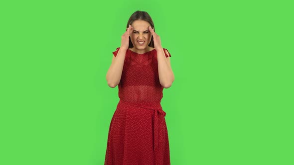 Tender Girl in Red Dress Is Suffering From Headache From Fatigue. Green Screen
