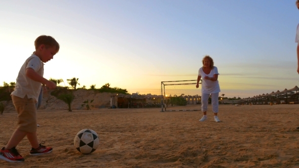 United Family Playing Beach Football