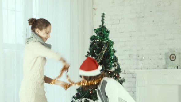 Two Girlfriends Wear Santa Hats To One Another