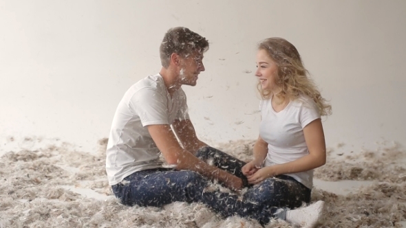 Cute Young Couple Sitting In Feathers