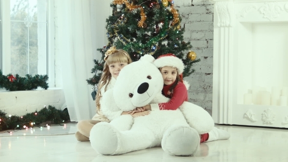 Two Girl Hiding Behind The Bear And Smiling