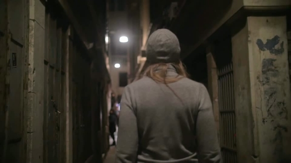 Woman Walking Along The Narrow Street alt