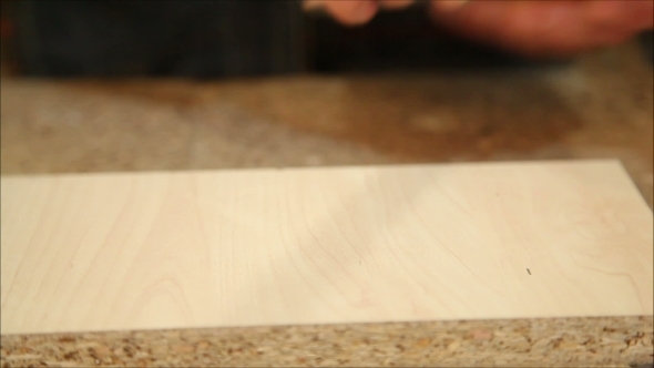 Worker Processes a Wooden Board