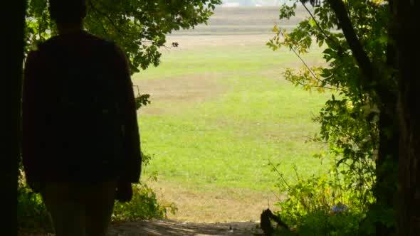 Silhouette Of The Man In The Shadows Of The Trees