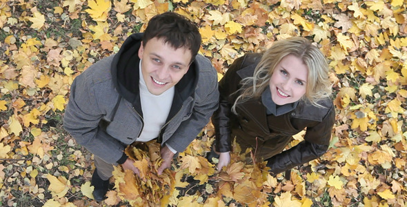 Couple throwing leaves