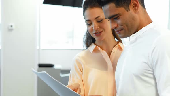 Business colleagues discussing over a file