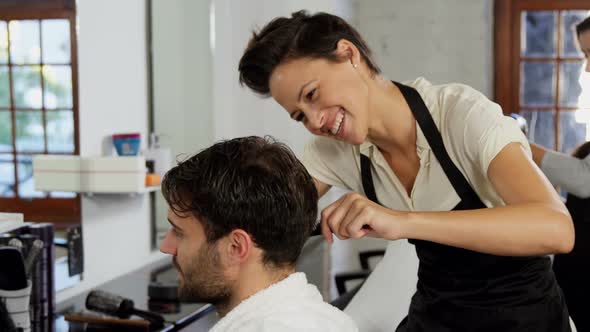 Hairdresser trimming her client hair