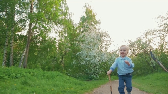 Happy Child Running On The Path In Park