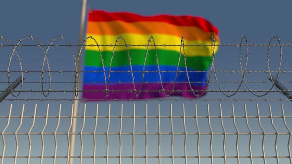 Barbed Wire Against Blurred Waving Gay Pride Flag