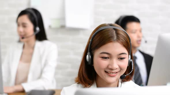 Asian telemarketing customer service agent team working in the office, call center job concept