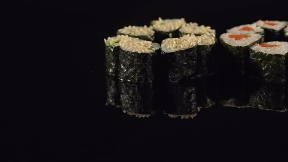 Set of Maki Sushi on a Black Surface Closeup