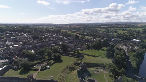 Aerial reverse reveal shot of Barnard Castle over the River Tees