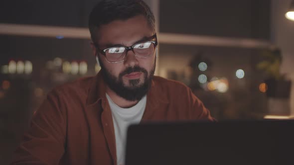 Businessman Talking on Video Call on Laptop in Evening