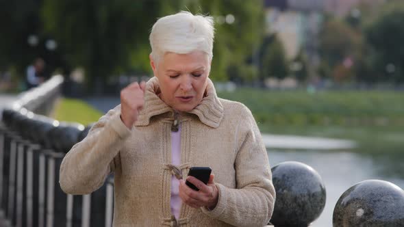 Overjoyed Happy Grayhaired Mature Woman Holding Smartphone Read Sms Notification Great News Looking