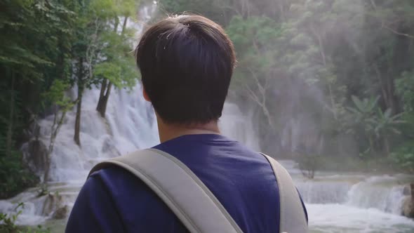 Man Looking At Waterfall