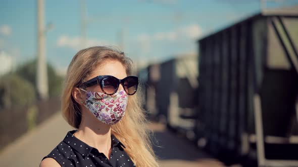 Female Waiting Train Wearing Protective Mask COVID19 Virus. Health And Safety Concept.