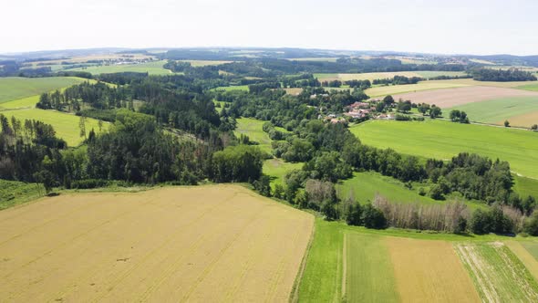 Aerial Drone Shot  a Rural Area with Forests Fields and a Village