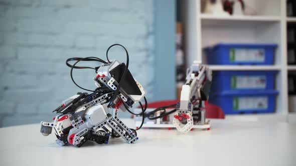 assembling a model of robotics from plastic toy blocks