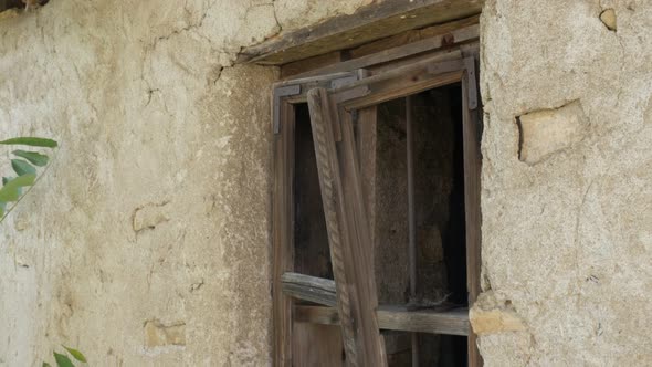 Abandoned mud house broken windows close-up 4K video