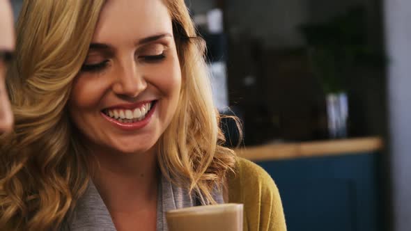 Smiling friends having a glass of cold coffee