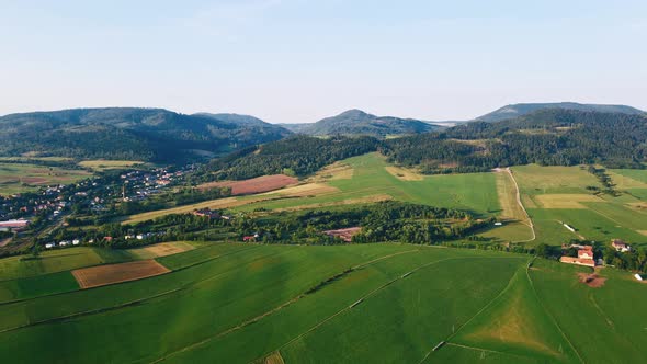 Landscape with Mountains Green Fields and Countryside Village Aerial View