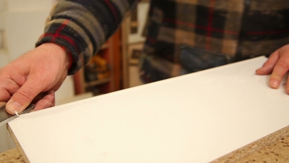 Worker Handles a Wooden Board 