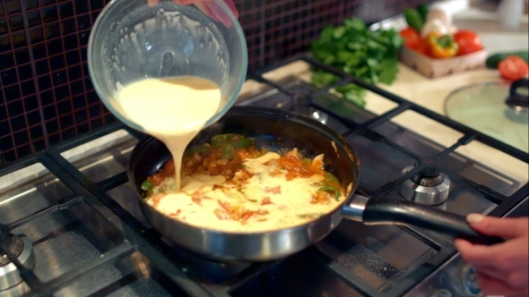 Cooking Omelette With Vegetables And Mushrooms