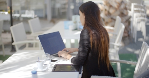 Businesswoman Typing On Her Laptop Computer alt