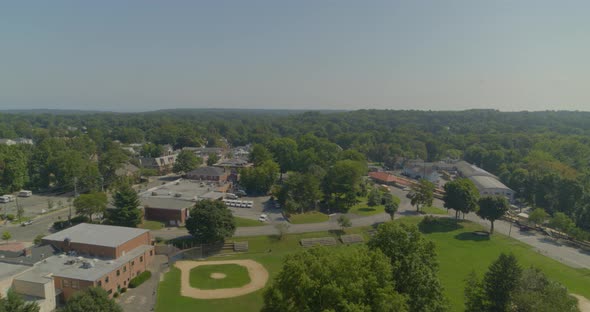 Flying Over a Small Residential Town Near a Forest in Long Island New York