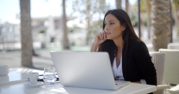 Businesswoman Sitting Thinking At a Restaurant alt