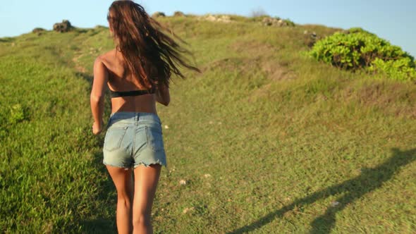 Asia Woman Run Beach Grass Valley on Greenery Cliff Top Looking on Seascape with Ocean Waves