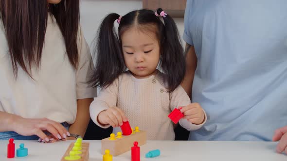 Asian Preschool Age Girl Playing with Educational Toy