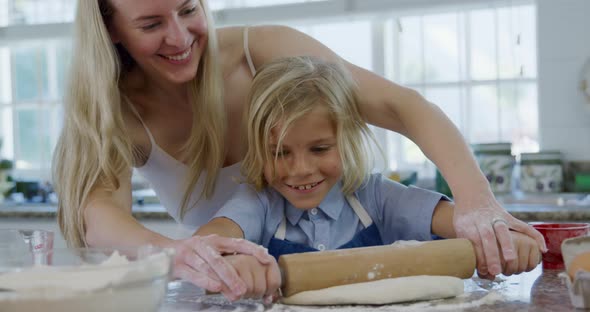 Mother and son making christmas cookies at home 4k