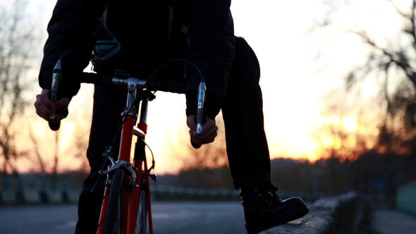 On the Road a Man Riding a Bicycle alt