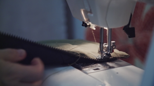 Woman Sews On The Sewing Machine