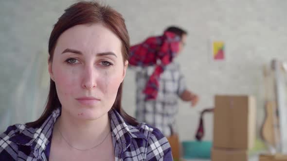 Unhappy Woman's Face During Divorce in the Background of the Moving Box