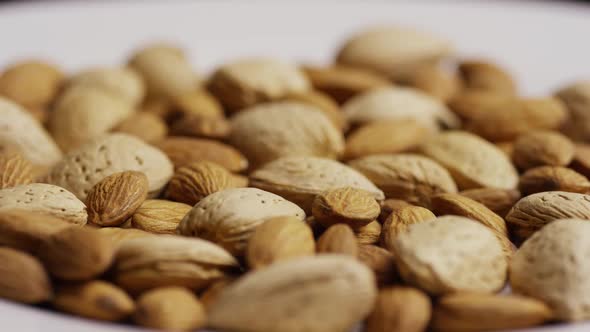 Cinematic, rotating shot of almonds on a white surface - ALMONDS 