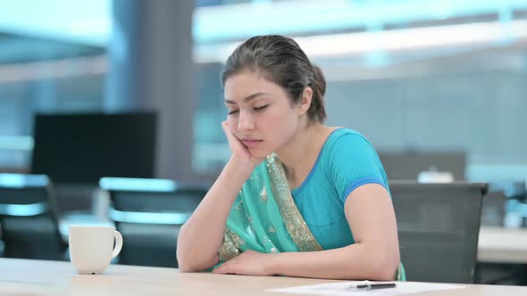 Indian Woman Taking Nap while Sitting at Work