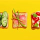 Set of toasted bread with avocado, smoked salmon, tomatoes and cucumbers on a yellow background - VideoHive Item for Sale