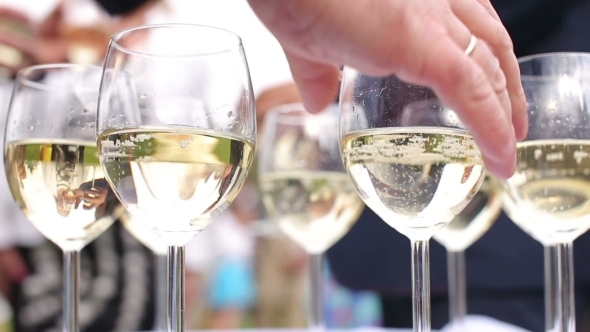 People Take Glasses Of Sparkling White Wine