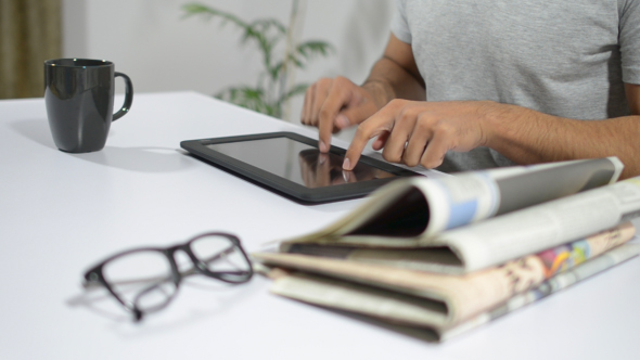 Man Typing Updates on Tablet alt