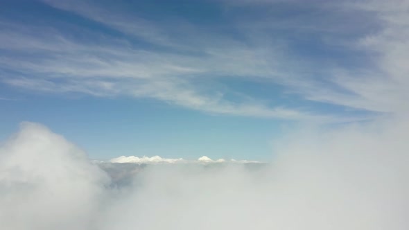 Aerial view lowering top of clouds