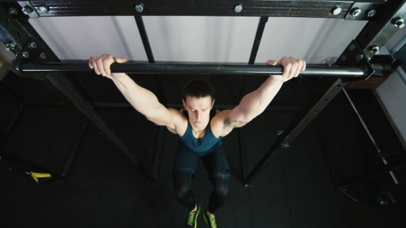 Athletic Man Pulled On The Bar Top View