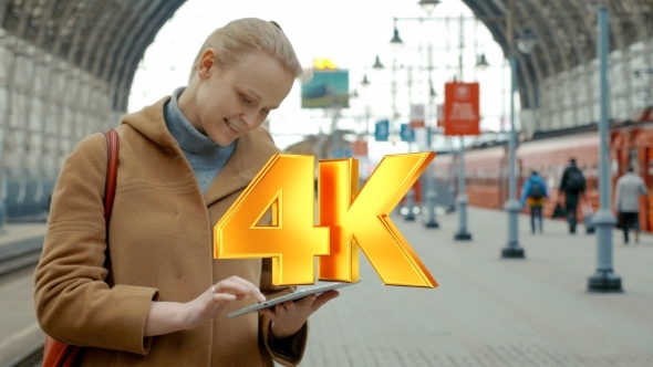 Woman With Tablet On The Railway Station