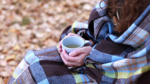 Woman Closed with a Blanket and Drinking Tea alt