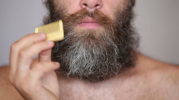 White Man Taking Care Of His Lush Beard And