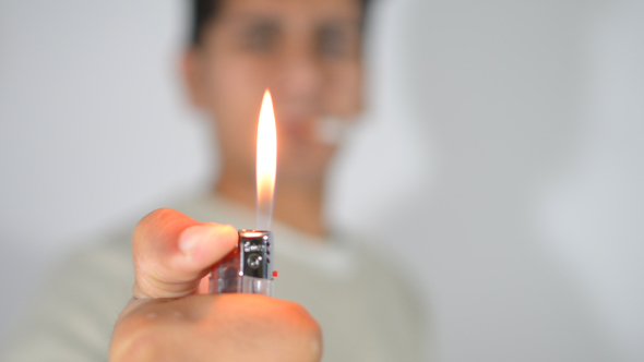 Smoking Man Burning Fire with Lighter