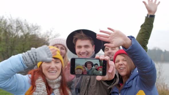 Group of Young Hipster Friends Make Selfie with Smartphone Camera. on the Background of Autumn